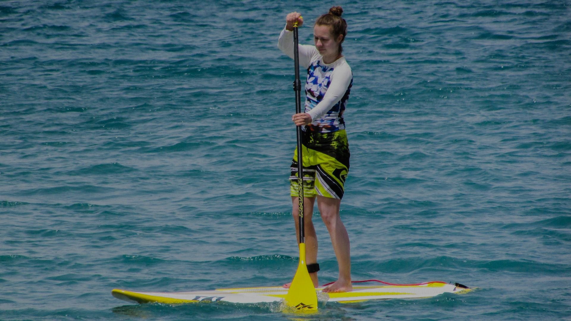 Person paddleboarding on a body of water
