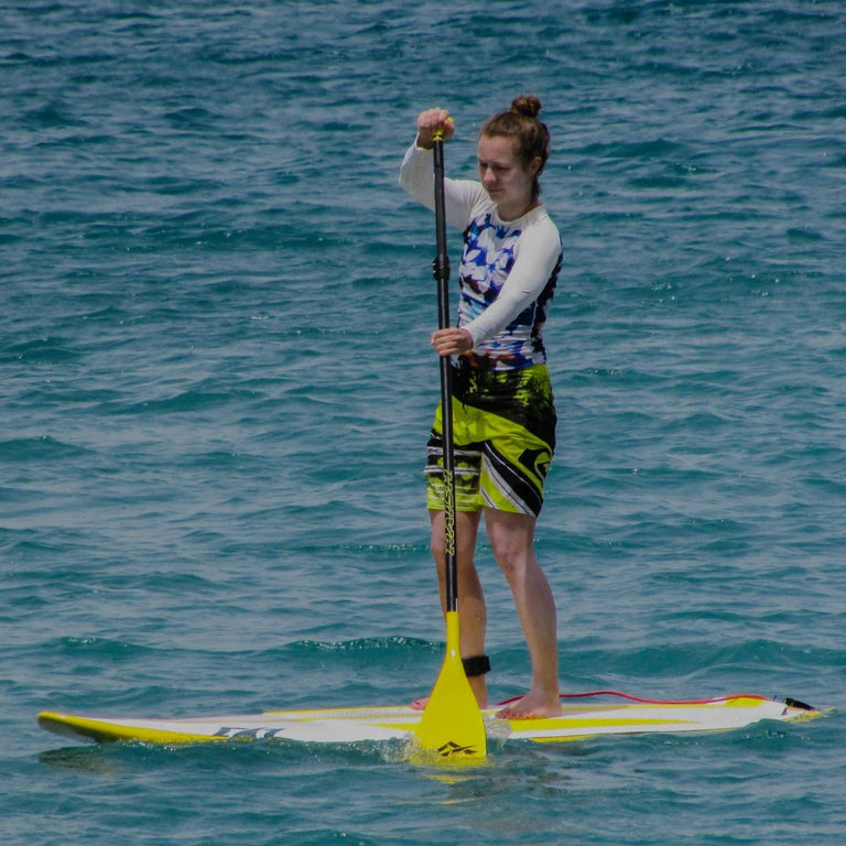 Person paddleboarding on a body of water